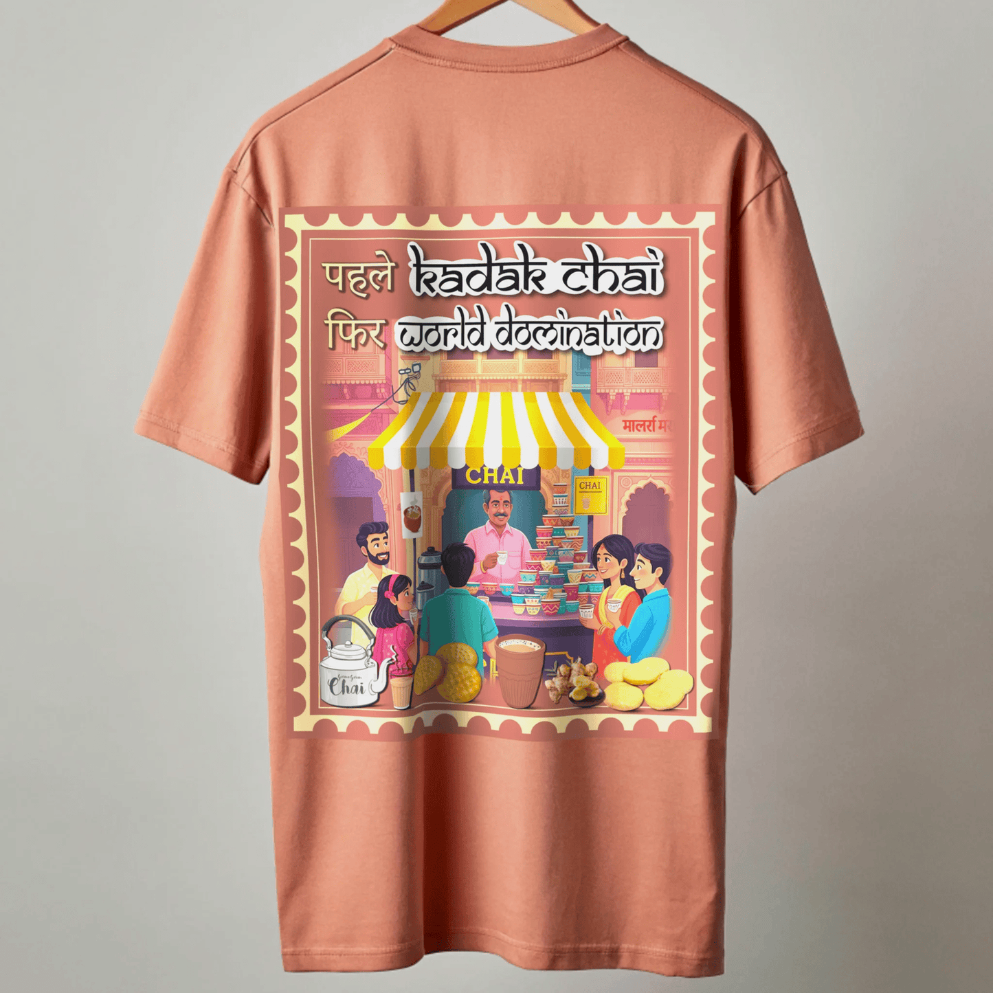 Coral t-shirt with a colorful tea stall graphic and KADAK CHAI WORLD DOMINATION text on a gray background by OFF THE RACK