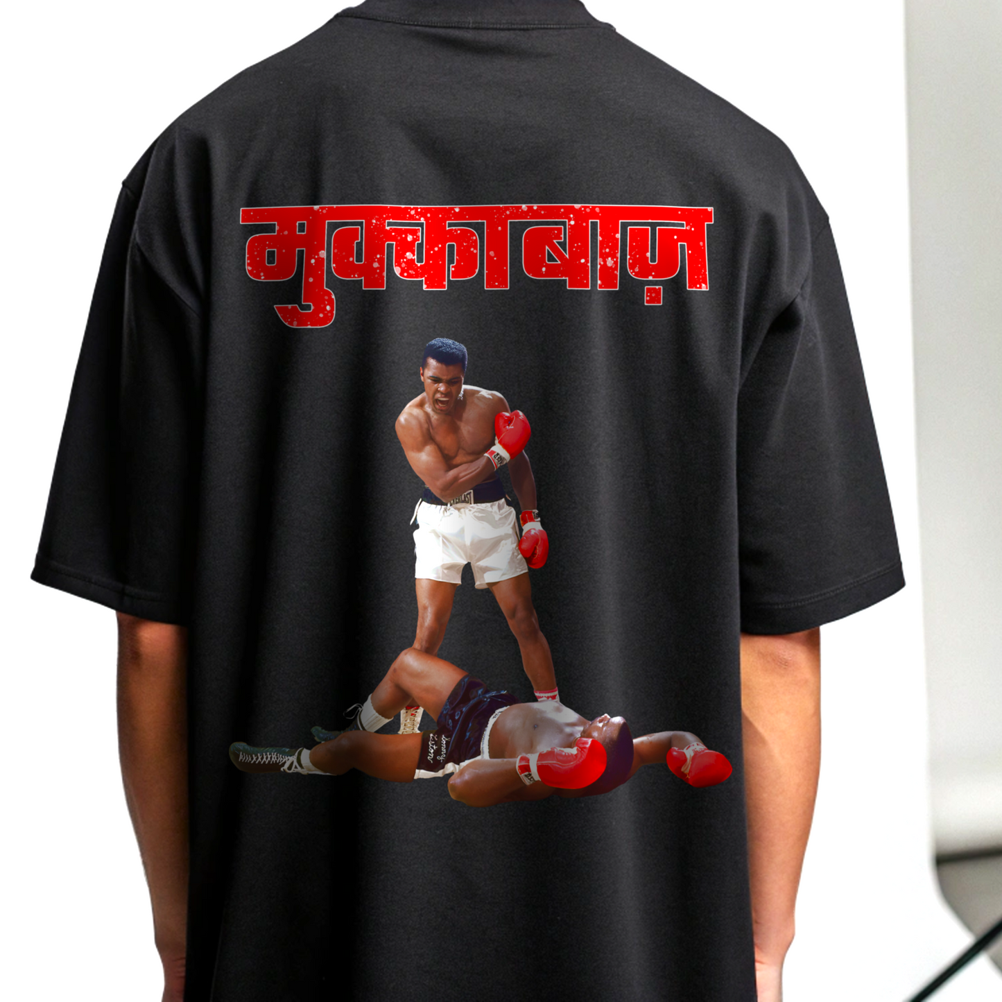 Black t-shirt with a graphic of two boxers and red MUKKEBAAZ text on the back By OFF THE RACK