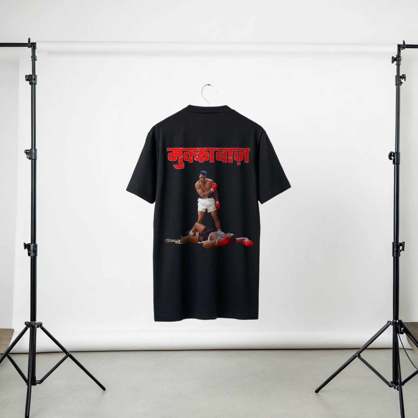 Black t-shirt with graphic of iconic Mohammad Ali and Red MUKKEBAAZ text on a white background in Studio Setup By OFF THE RACK