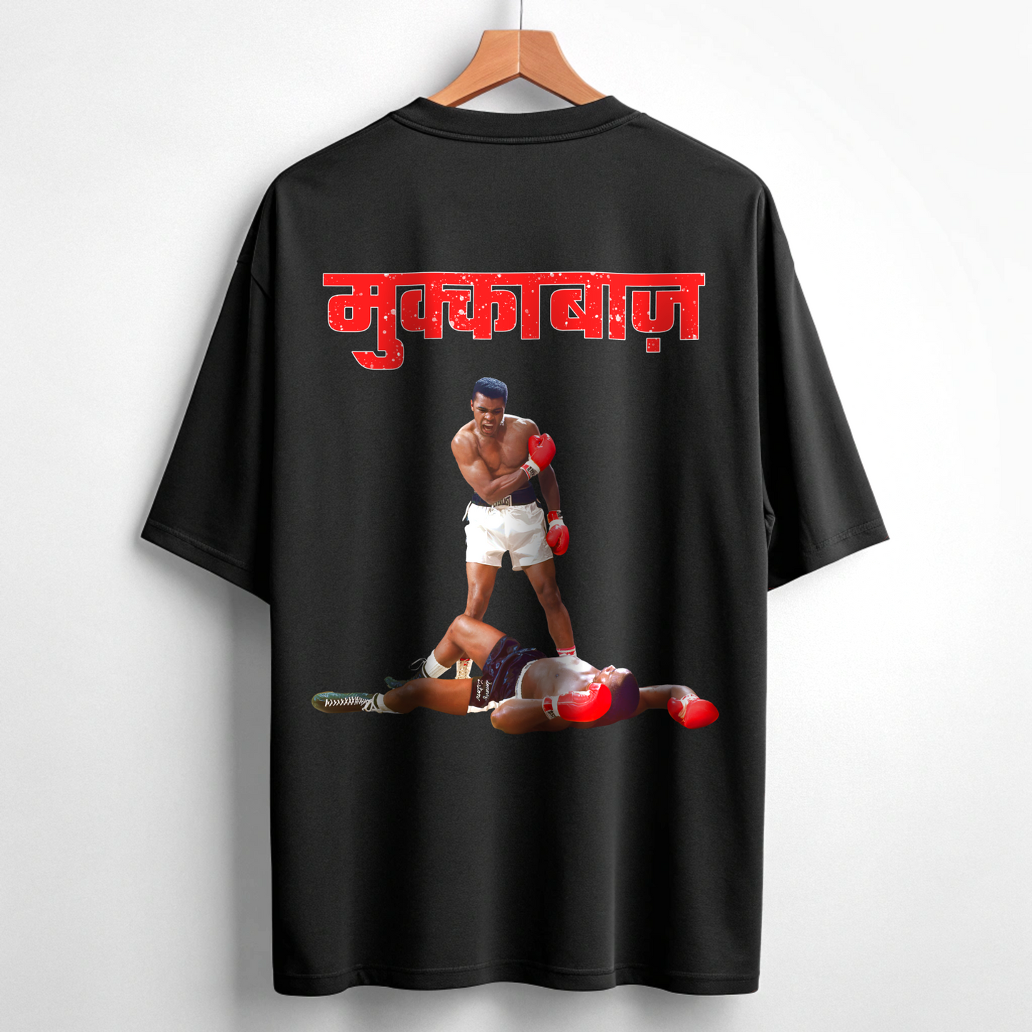 Black t-shirt with a graphic of two boxers and red text on a hanger against a white background By OFF THE RACK