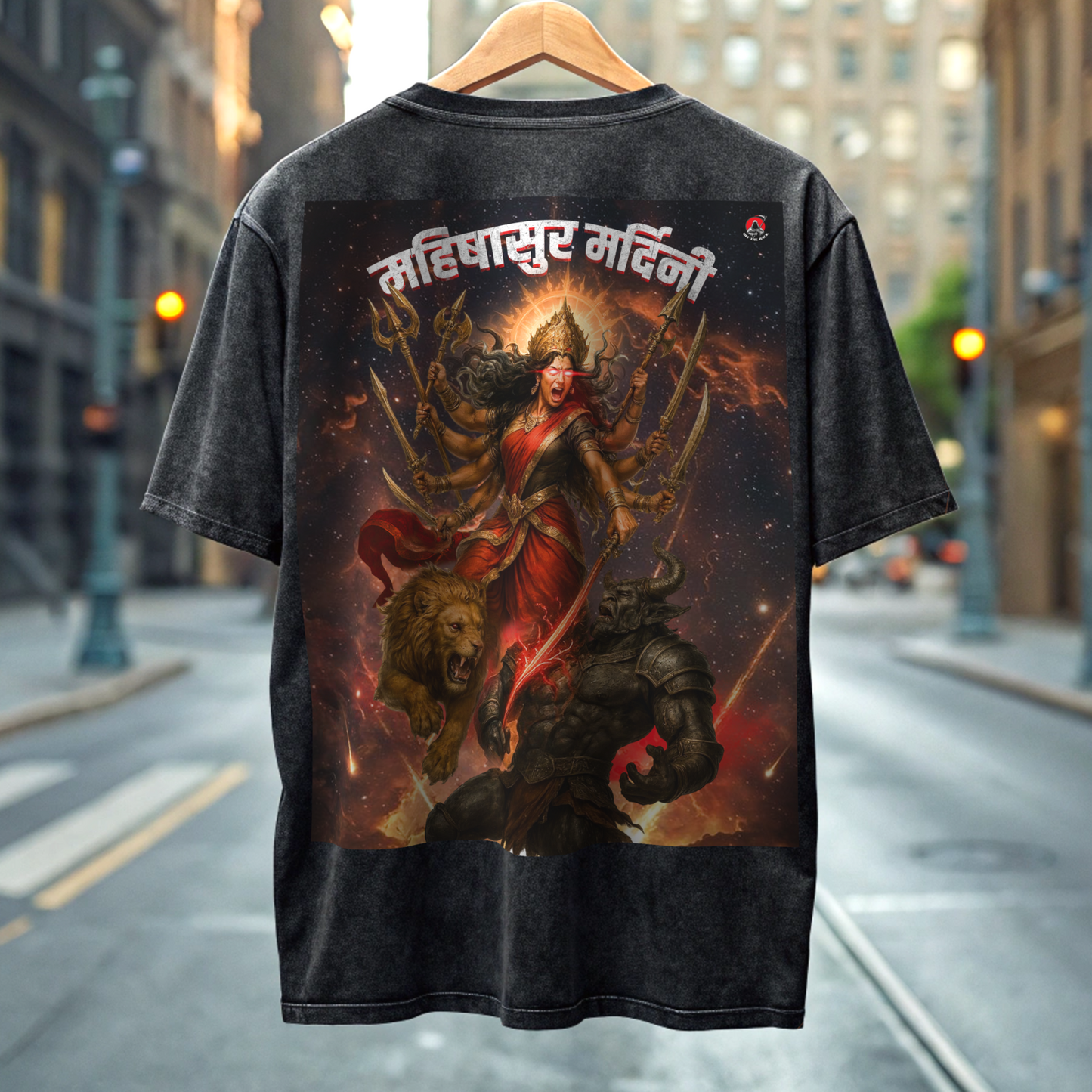 Black acid washed t-shirt with a colorful graphic design of fierce durga on a hanger against a city street background By OFF THE RACK