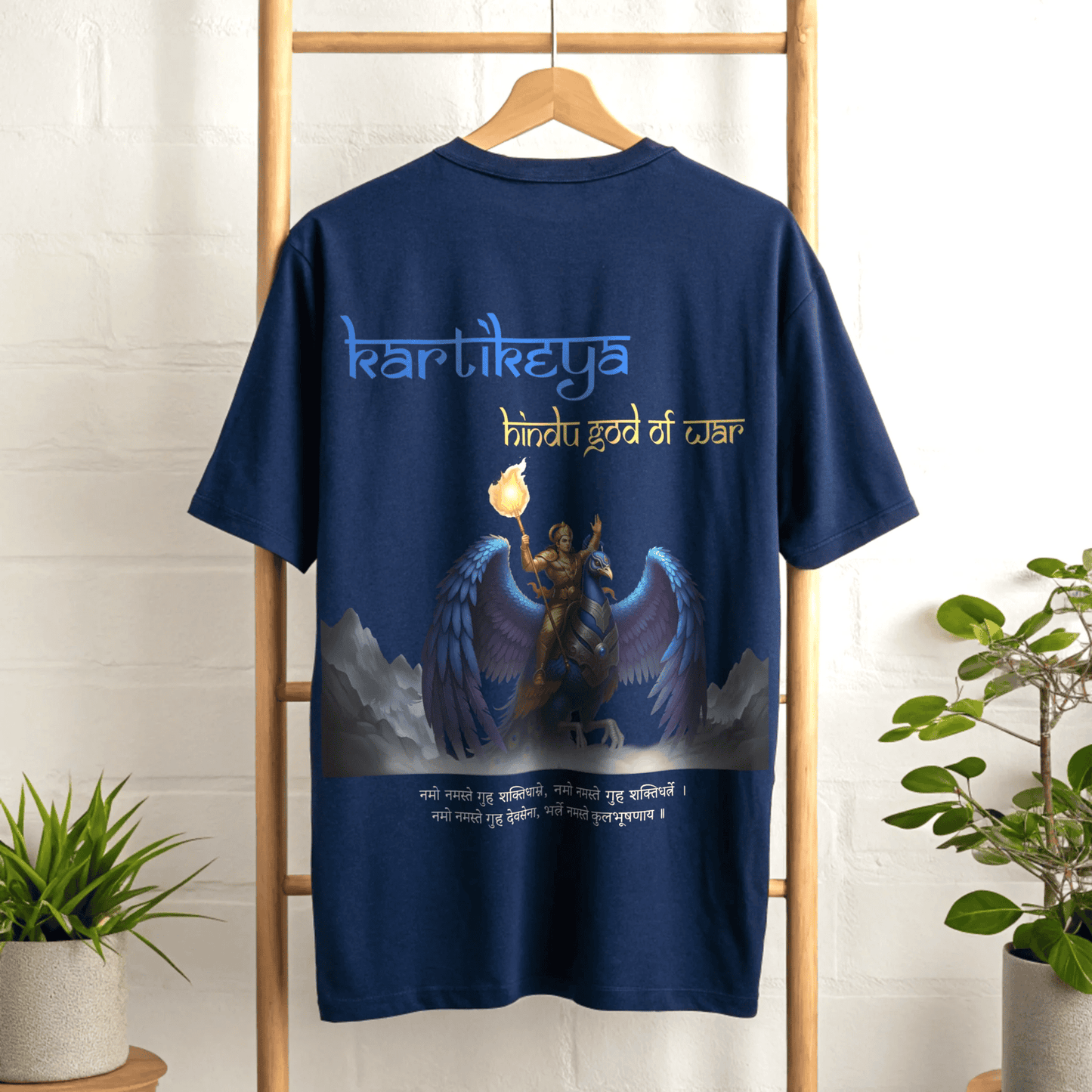 Royall Blue t-shirt with a graphic design and Kartikeya Hindu God Of War text on a wooden hanger against a white wall By OFF THE RACK