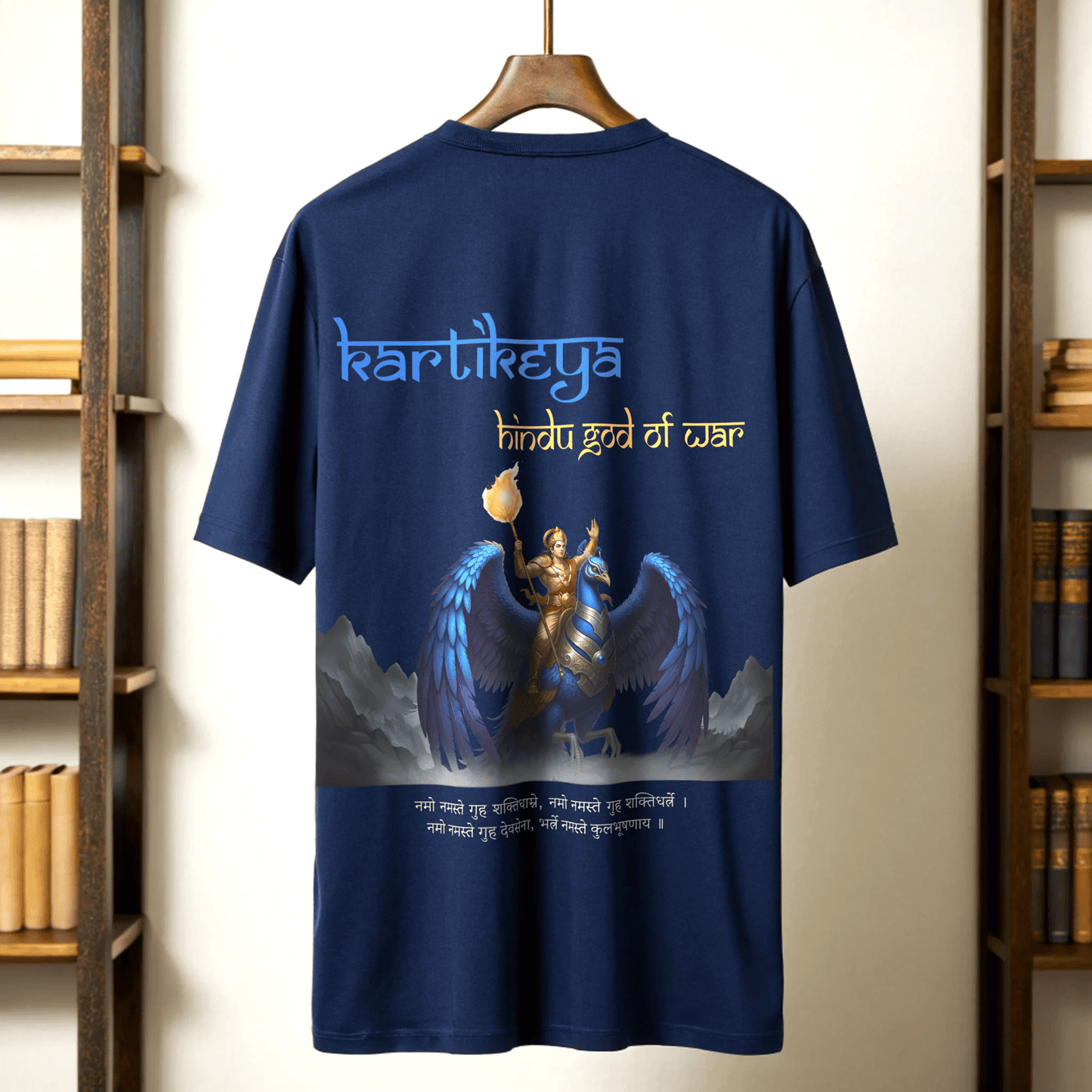 Royal blue t-shirt with a graphic of Kartikeya, the Hindu god of war, on a wooden hanger against a bookshelf background By OFF THE RACK