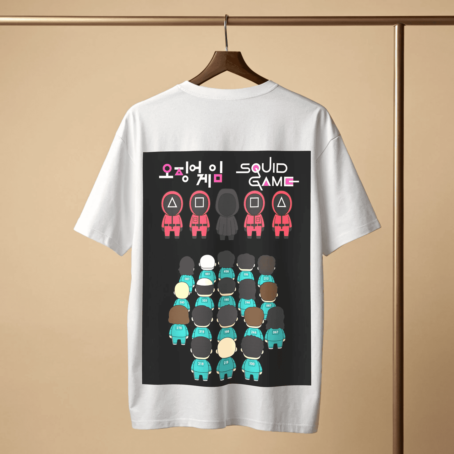 White t-shirt with 'Squid Game' graphic design on a wooden hanger with beige background By OFF THE RACK.