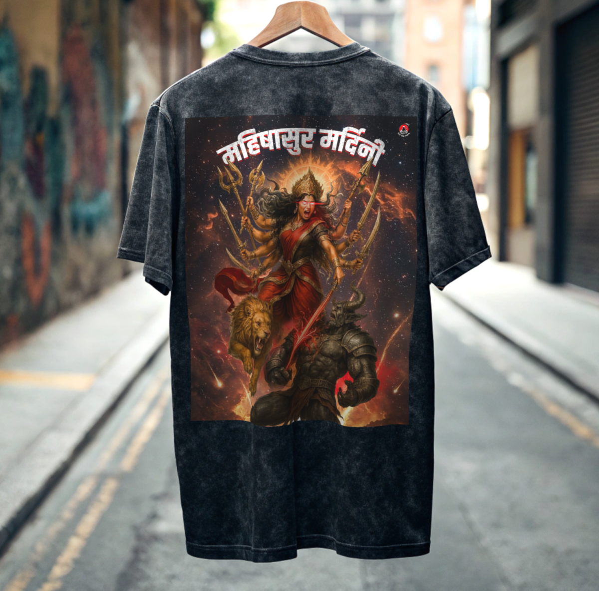 Black Acid Wash t-shirt with a colorful graphic design Of Fierce Durga on a hanger against an urban street background By OFF THE RACK