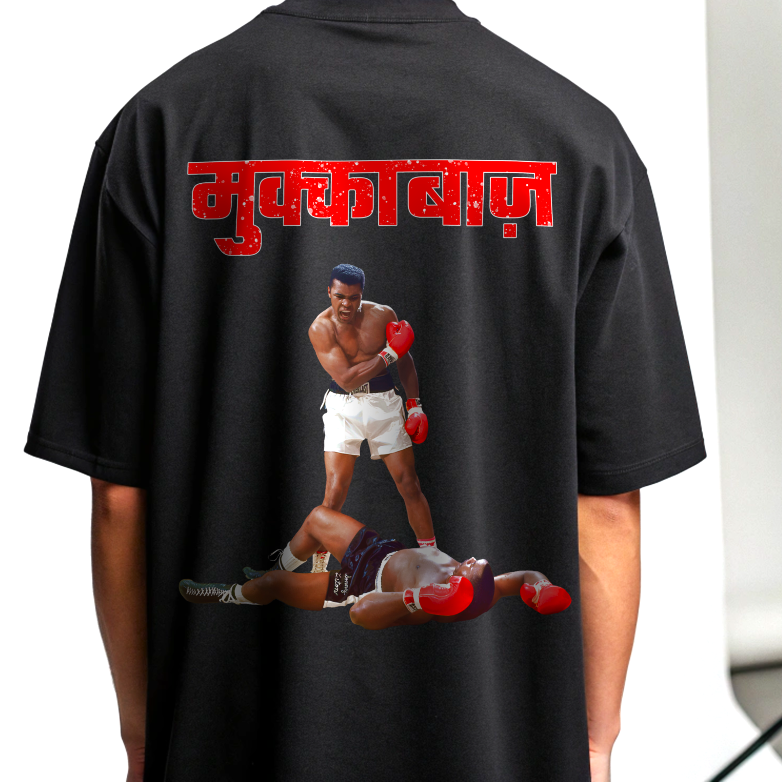 Black t-shirt with a graphic of two boxers and red MUKKEBAAZ text on the back By OFF THE RACK