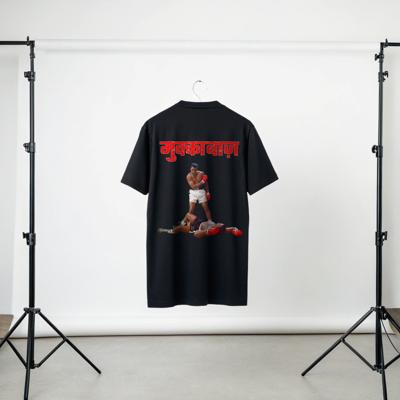 Black t-shirt with graphic of iconic Mohammad Ali and Red MUKKEBAAZ text on a white background in Studio Setup By OFF THE RACK