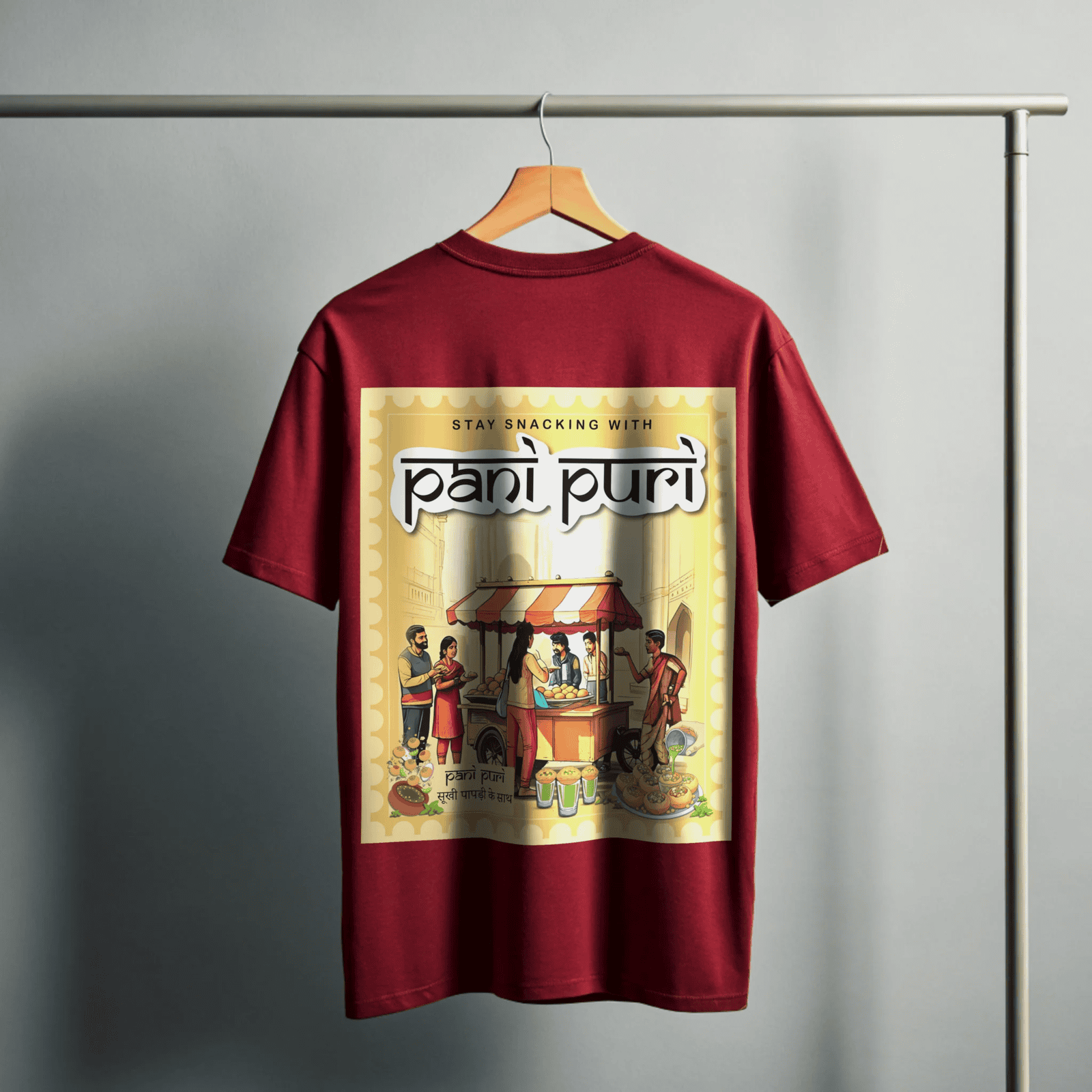 Red t-shirt with 'pani puri' graphic design on a hanger against a gray background By OFF THE RACK