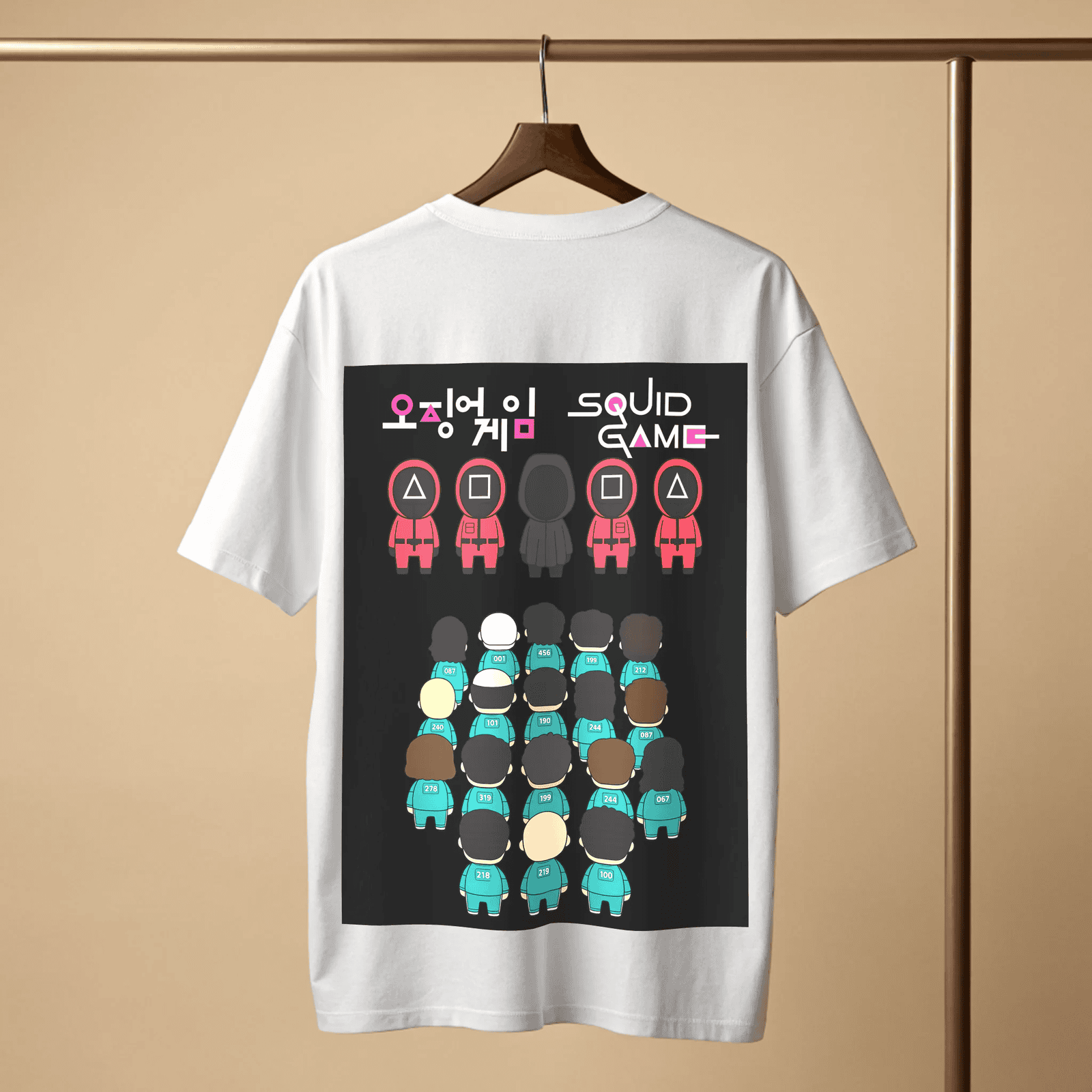 White t-shirt with 'Squid Game' graphic design on a wooden hanger with beige background By OFF THE RACK.